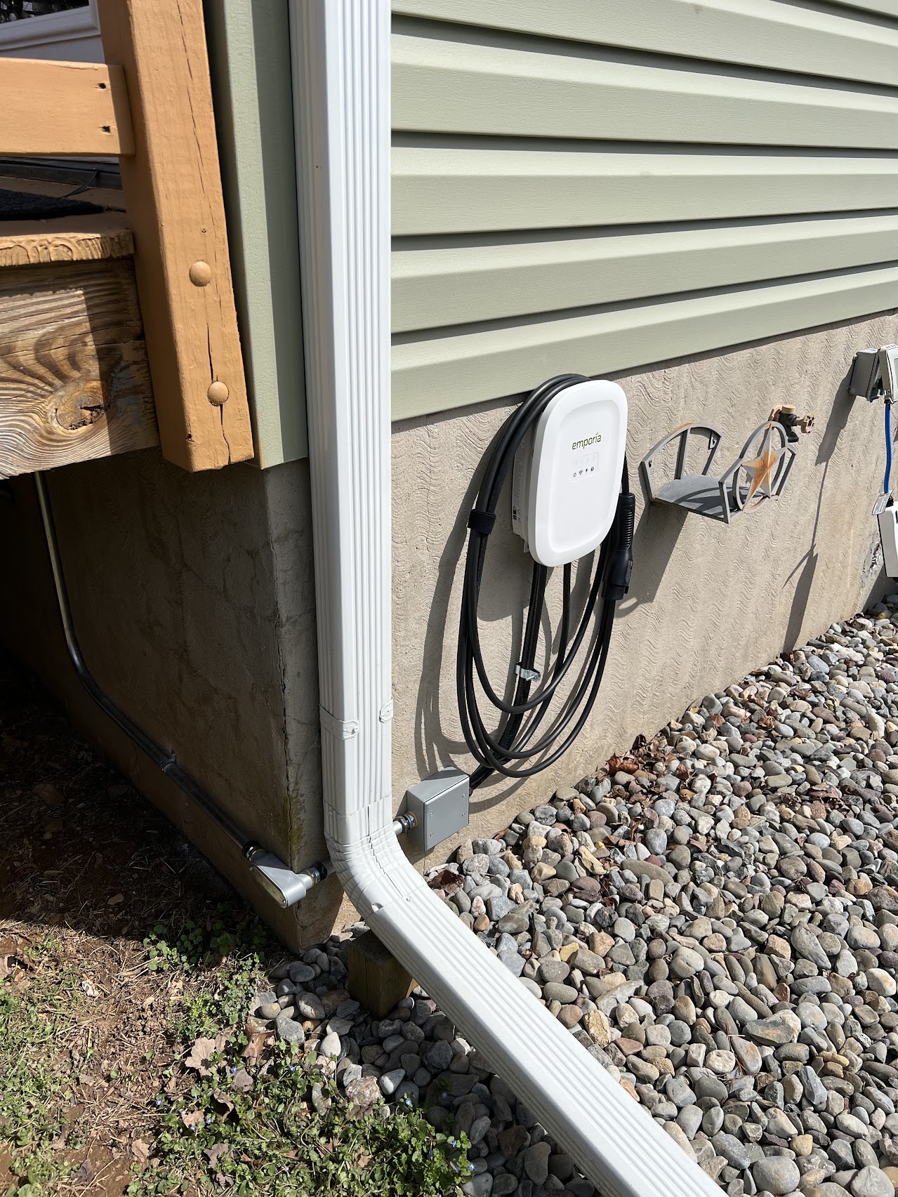 White Emporia Level 2 EV charger installed on an exterior wall